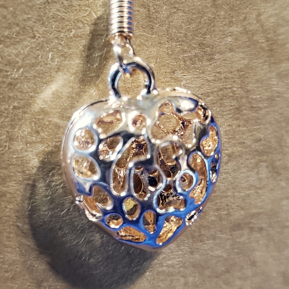 Rose Gold colored Heart earrings with intricate cuts for dimension.